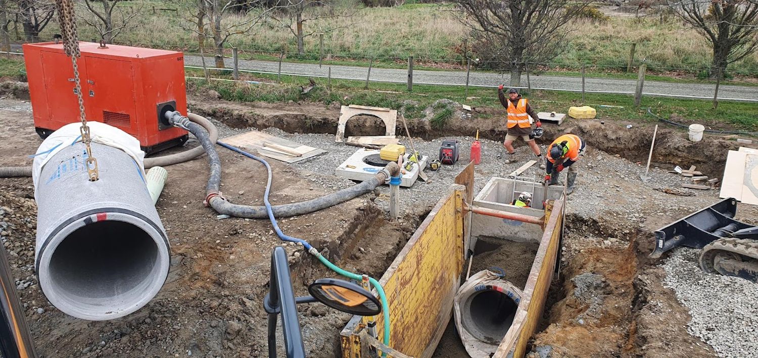 The Smart Contracting fleet and crew on a Christchurch drainage job