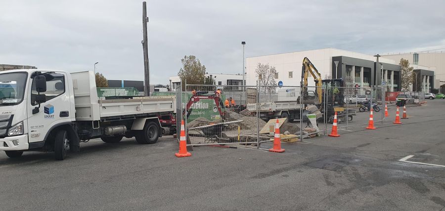 Smart Contracting tip truck and excavator on a commercial drainage site in Christchurch