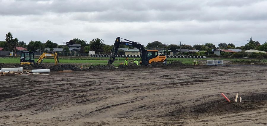 Excavators working on a large civil drainage site in Canterbury