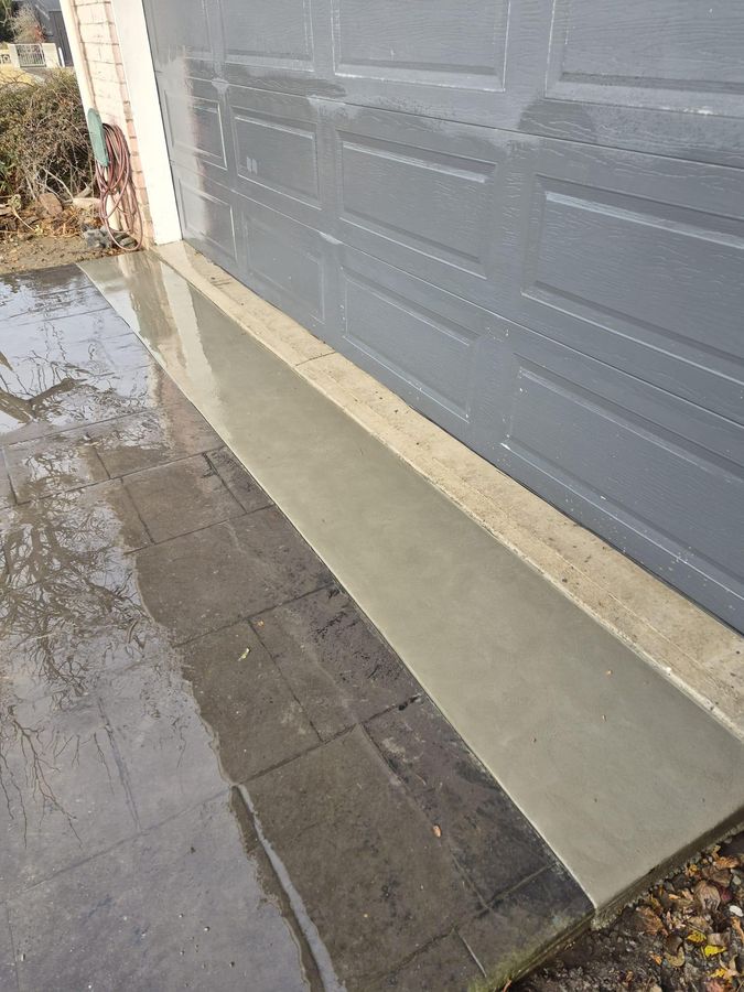 New concrete apron at a garage door after drainage repair work in Christchurch