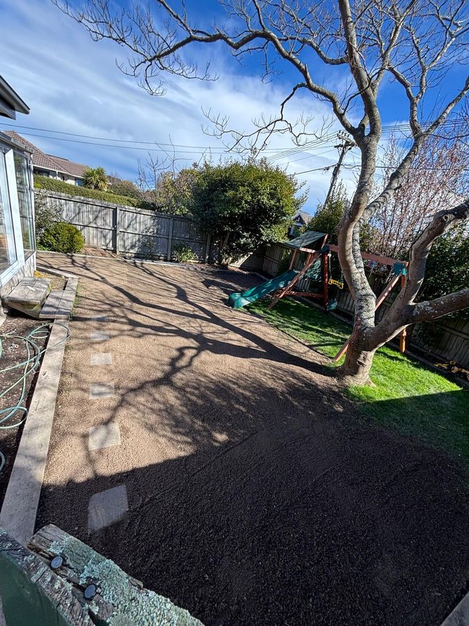 Fresh topsoil spread over completed drainage repairs in a Christchurch back yard
