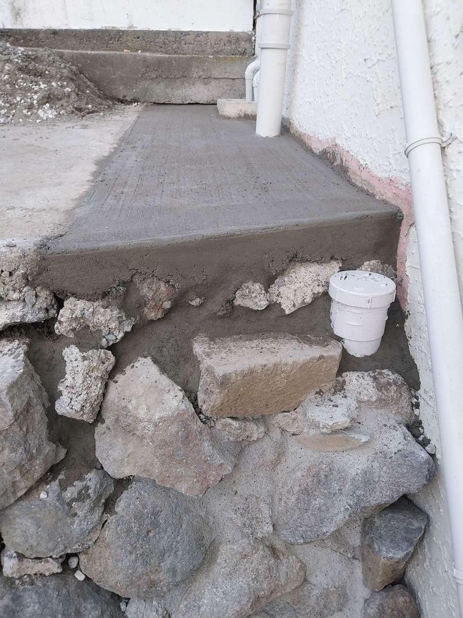 Fresh concrete and a new gully riser completing a drain repair in Christchurch
