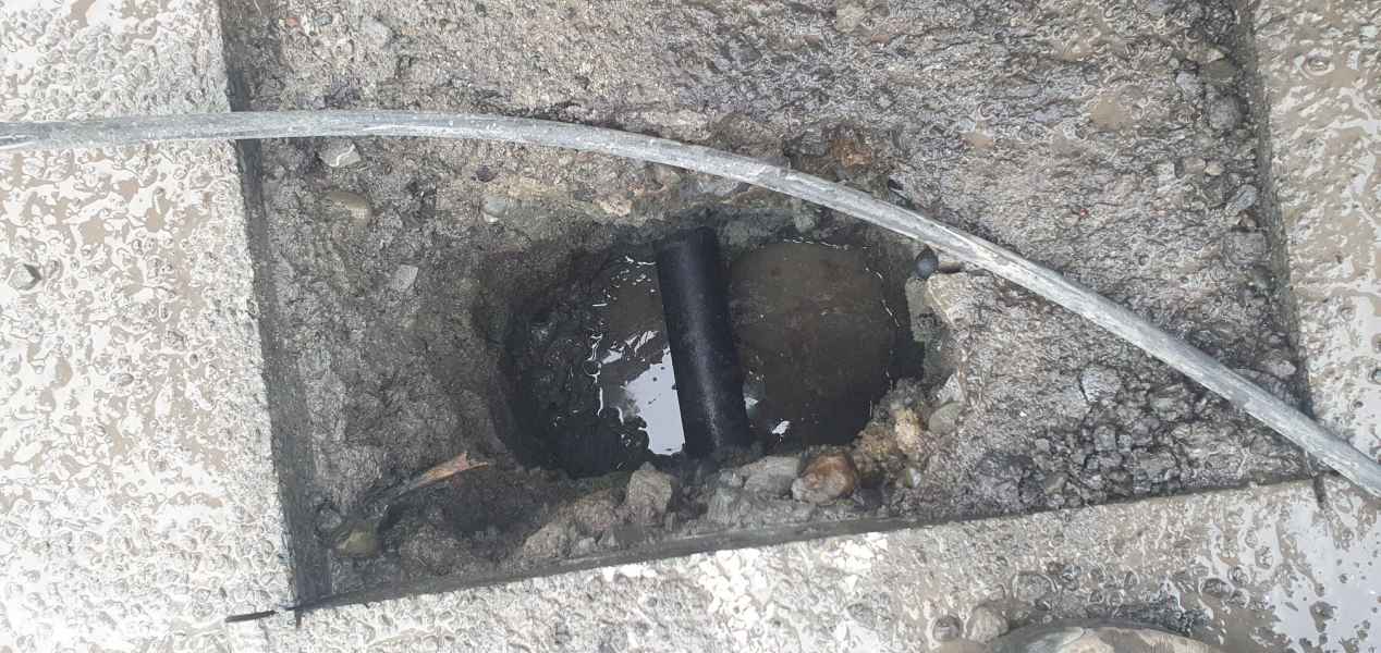 Concrete cut open to reach a blocked drain line under a Christchurch driveway