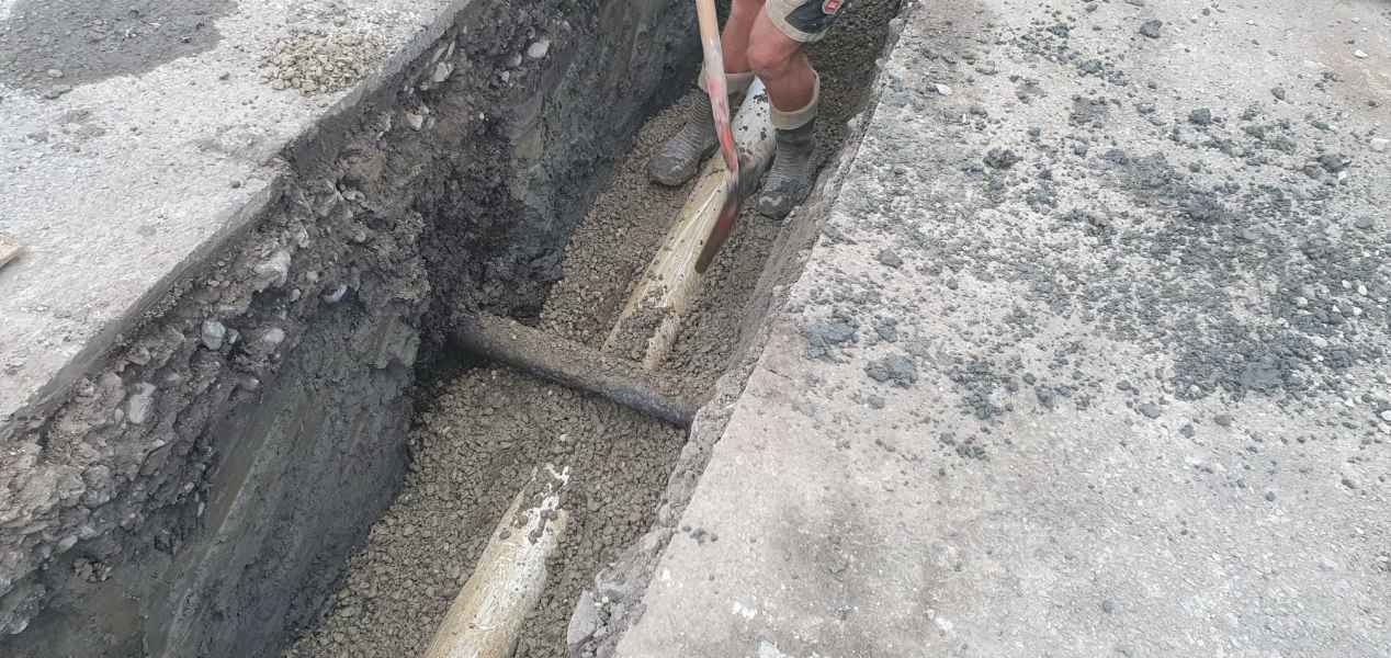 Narrow slot cut through concrete to expose and repair a drain in Christchurch