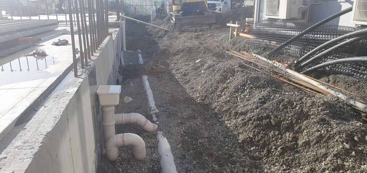 Drainage trench alongside a commercial building foundation in Christchurch