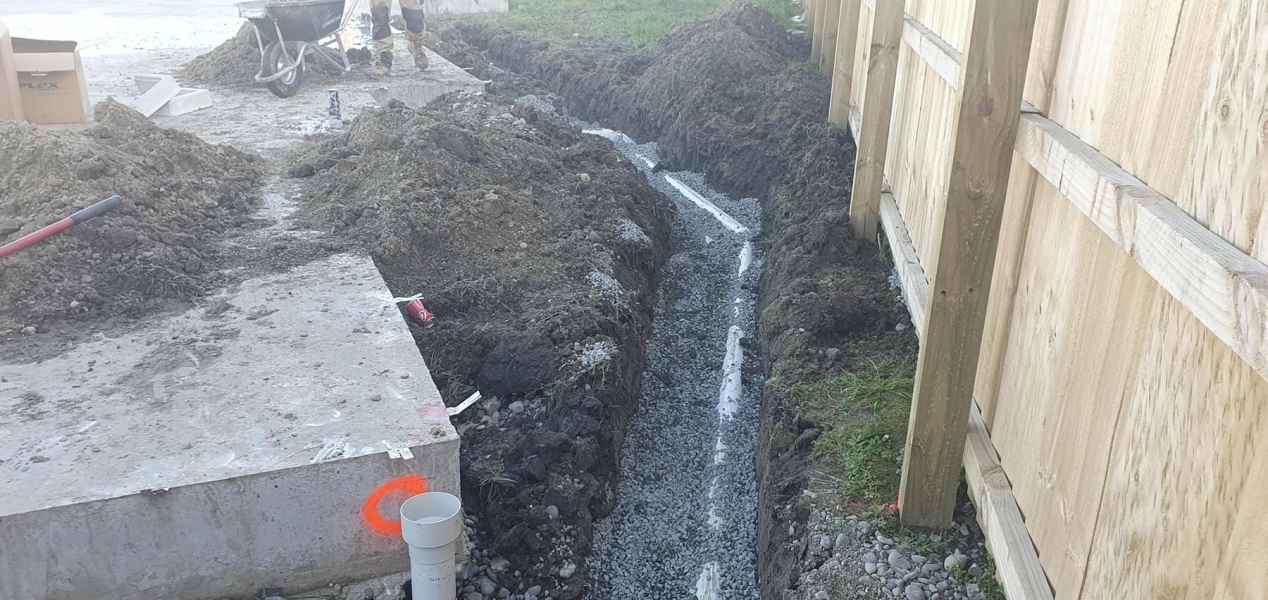 Gravel bedded drainage trench alongside a new house slab in Christchurch