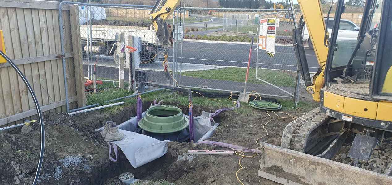 Pressure sewer tank collar bedded in gravel in Christchurch