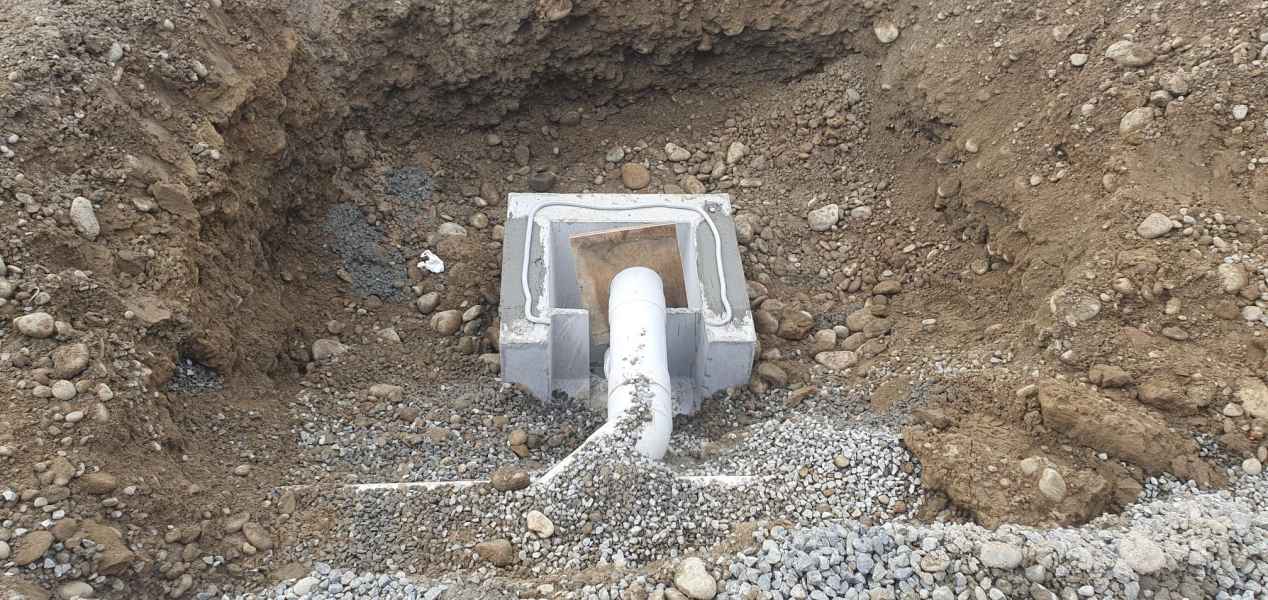 New gully trap and pipe bedded in gravel on a Christchurch residential drainage job
